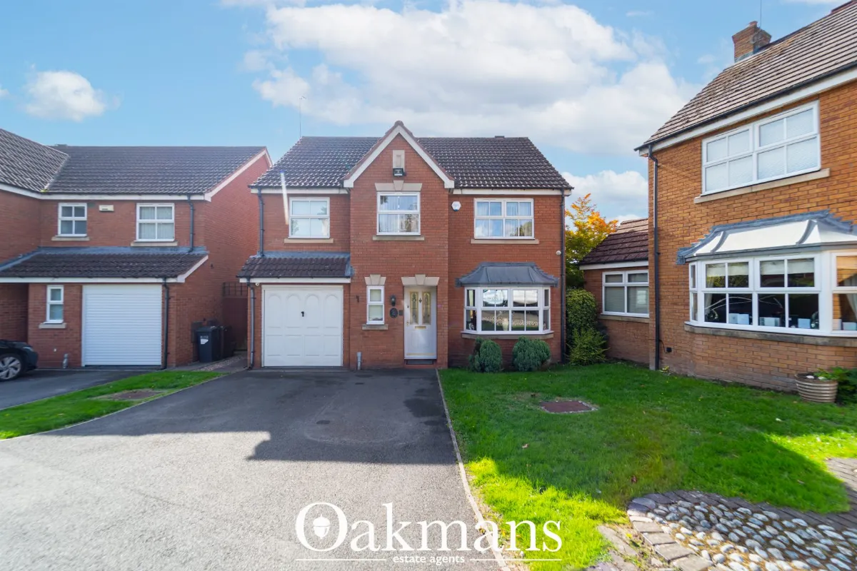 A modern red-brick detached house with an attached garage, driveway and front lawn on Maple Leaf Drive