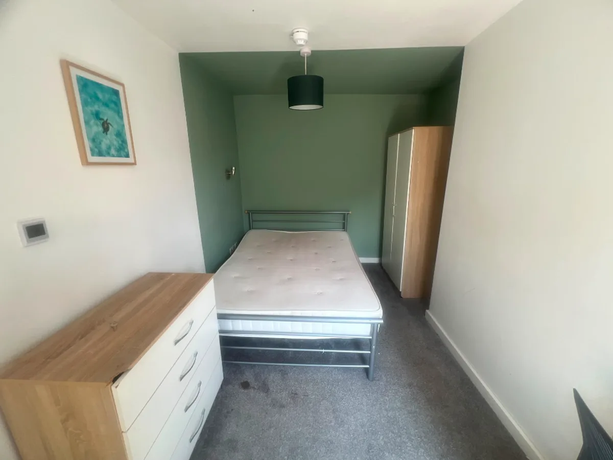 The same bedroom before staging — bare walls and an unfurnished space